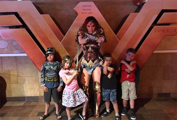 Anya posing with Wonder Woman cutout