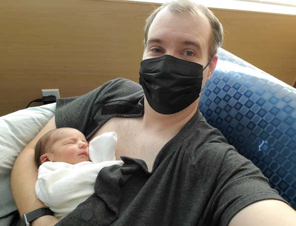 holding Julian with mask